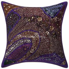 a purple and gold pillow with sequins on it