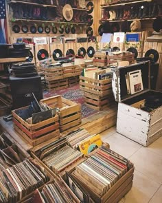 a room filled with lots of old records and record player's boxes on the floor