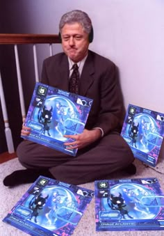 a man sitting on the floor holding up some cards