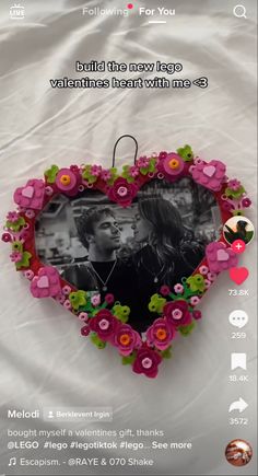 a heart shaped frame with flowers on it