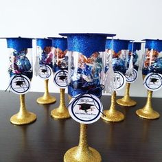 there are many glasses that have been decorated with blue and gold glitters on them