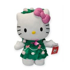 a hello kitty stuffed animal wearing a green dress