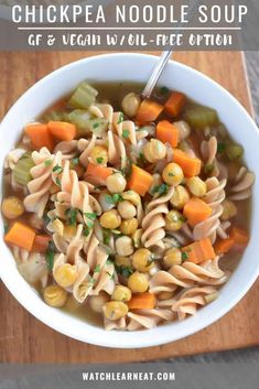 a bowl of chicken noodle soup with carrots, celery and noodles