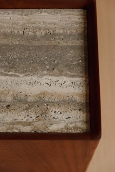 a close up of a piece of wood with sand and gravel in it on a table