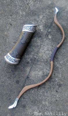 a snake like object is laying on the ground with it's tail curled up