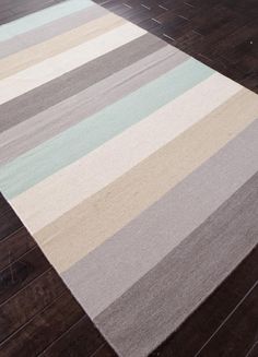 a multicolored striped rug is on the floor