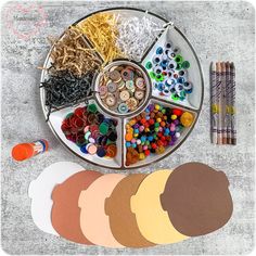 a plate filled with lots of different types of crafting supplies on top of a table