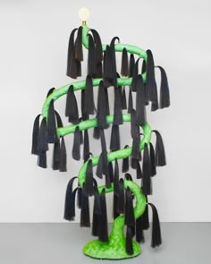 a sculpture made out of black and green hair