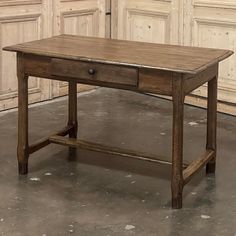 an old wooden table with two drawers on one side and another drawer on the other