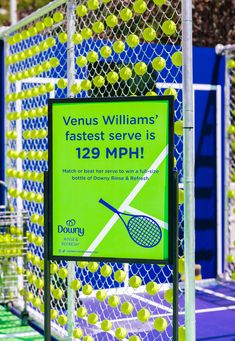 a tennis racket and ball display in front of a fence with the words venus williams'fastest serve is 19 mph