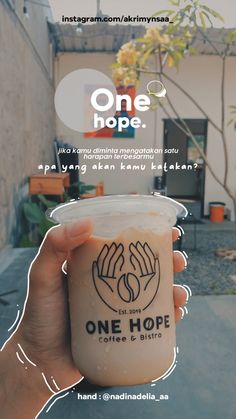 someone holding up a cup of coffee with the words one hope on it