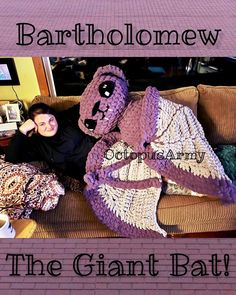 a woman laying on top of a couch next to a giant stuffed animal in a crocheted blanket