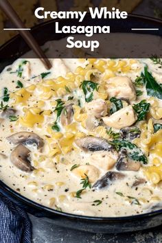 creamy white lasagna soup with mushrooms and spinach in a black bowl on a table