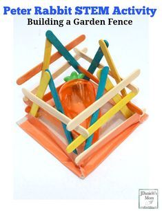 an image of a building a garden fence made out of popsicles and sticks