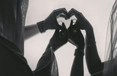 two hands making a heart shape with their fingers