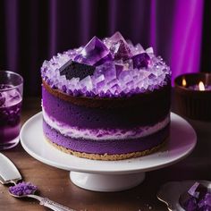 a cake with purple icing and ice cubes sitting on top of a white plate