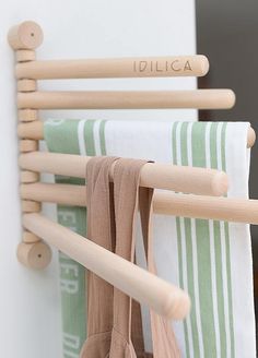 three towels hanging on a rack in front of a door with the word idlica written on it