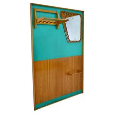 a wooden door with a mirror and shelf on it