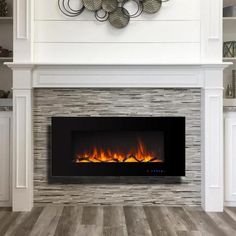 a white fireplace with an electric fire in it