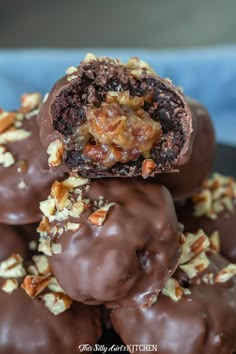 chocolate covered donuts stacked on top of each other with walnuts and pecans