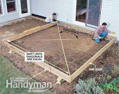 two men are working on the foundation of a house