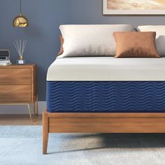 an image of a bed with blue and white mattresses on it's side