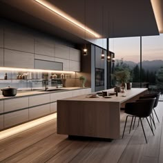 a modern kitchen with wooden floors and large windows overlooking the mountains at dusk, is illuminated by recessed lighting