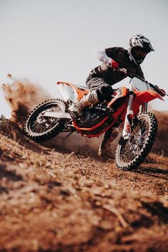 a man riding on the back of a dirt bike