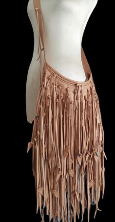 a mannequin torso with leather fringes on it