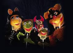 the muppets are dressed in costumes and holding microphones with their mouths open