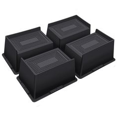 four black plastic boxes sitting on top of each other