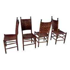 set of four chairs with woven seat cushions