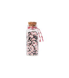 a glass jar filled with candy canes and sprinkles