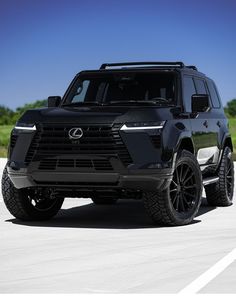 a black suv is parked on the road