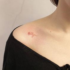 a woman with a small tattoo on her chest