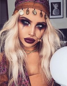 a woman with makeup and jewelry on her face