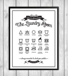 the laundry room printable poster on a wooden wall with wood planks behind it