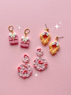 three pairs of earrings on a pink background