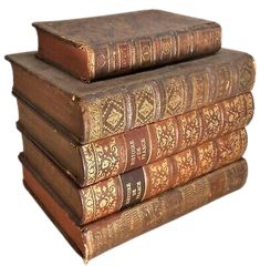 three old books stacked on top of each other