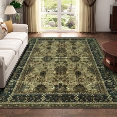 a living room with a large rug on the floor next to a couch and coffee table