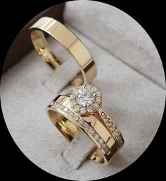 two gold wedding rings with diamonds on them