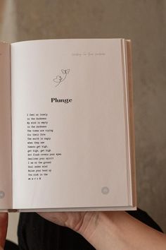 a person holding an open book in their hand with the words plunge written on it