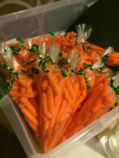 carrots are wrapped in plastic bags with green sprinkles on the top