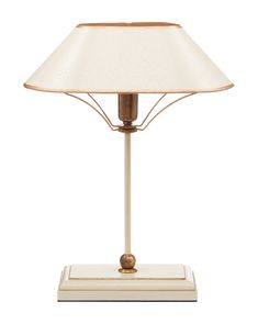 a table lamp with a white shade on it's base and gold trimming