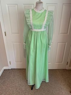 This nice vintage 1970's Mint green & white Swiss Dot and Lace Pinafore dress comes to you in a size small. The dress is a high waist style fully lined-has sheer sleeves and giant ruffle at bottom with lace trim-Has the Pinafore Front-In great vintage cond-Pls compare the measurements I give you to those in your closet-They are as follows- -14 3/4 to 15 inches shoulder to shoulder -25 1/2 inches shoulder to bottom of sleeve -waist is 14 inches across -hips N/A -49 inches underarm to bottom o 70s Prairie, Seventies Fashion, Design Clothes, Maxi Styles, Pinafore Dress, Fashion Design Clothes, Swiss Dot, Sheer Sleeves, Stunning Dresses