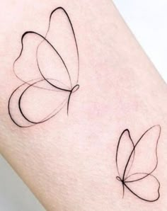 two butterfly tattoos on the thigh