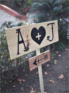 a wooden sign with the word love and an eiffel tower on it's side