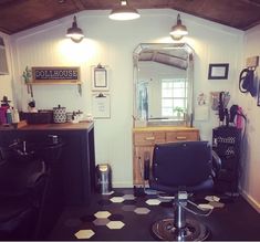 a hair salon with black chairs and lights