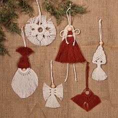 christmas ornaments are hanging on a burlock with twine and tassels