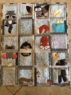 a quilted wall hanging with many different animals on it